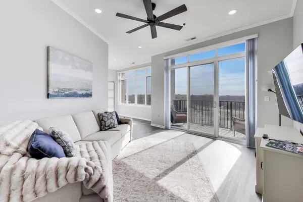 a spacious bedroom with a bed and glass window