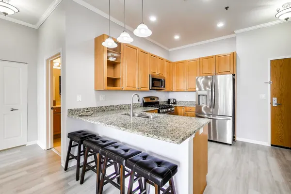 a kitchen with a table chairs refrigerator and microwave