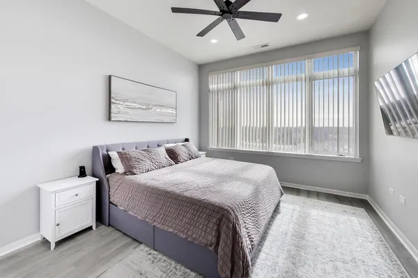 a bedroom with a large bed and a window