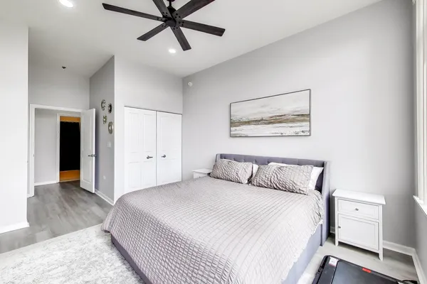 a bedroom with a large bed and a chandelier