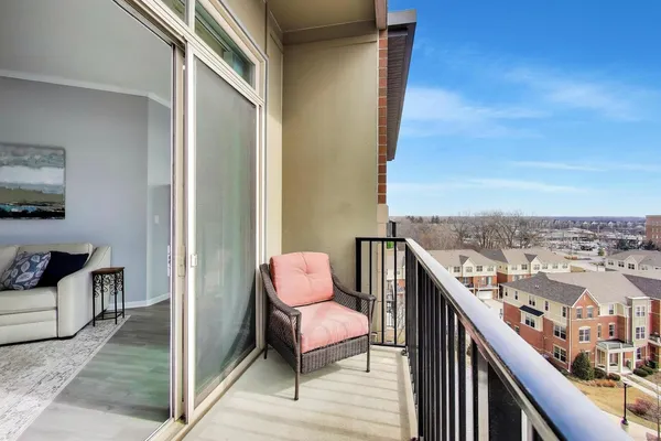 a balcony with chairs and a table