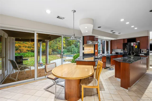 a view of a dining room with furniture wooden floor and a chandelier