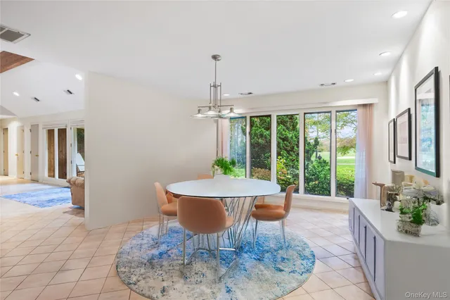 a dining room with furniture a chandelier and wooden floor