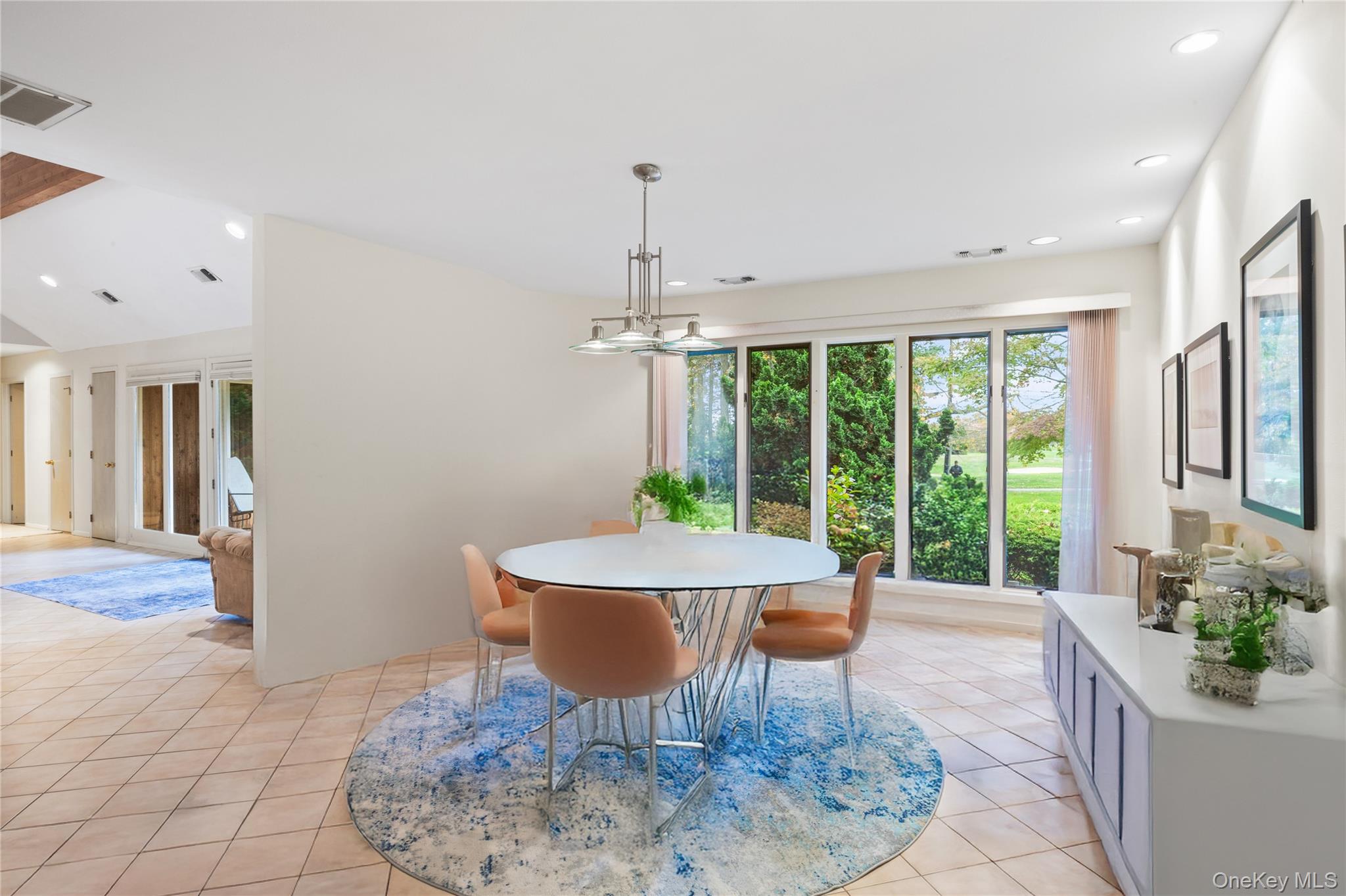 18 Golf Club Road St. James, NY 11780 - Photo 13 of 47 a dining room with furniture a chandelier and wooden floor
