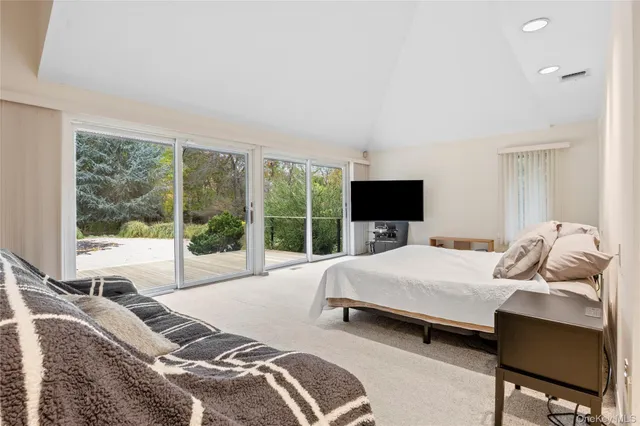 a bedroom with a bed and large window