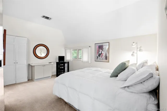 a bedroom with a bed and a lamp on table