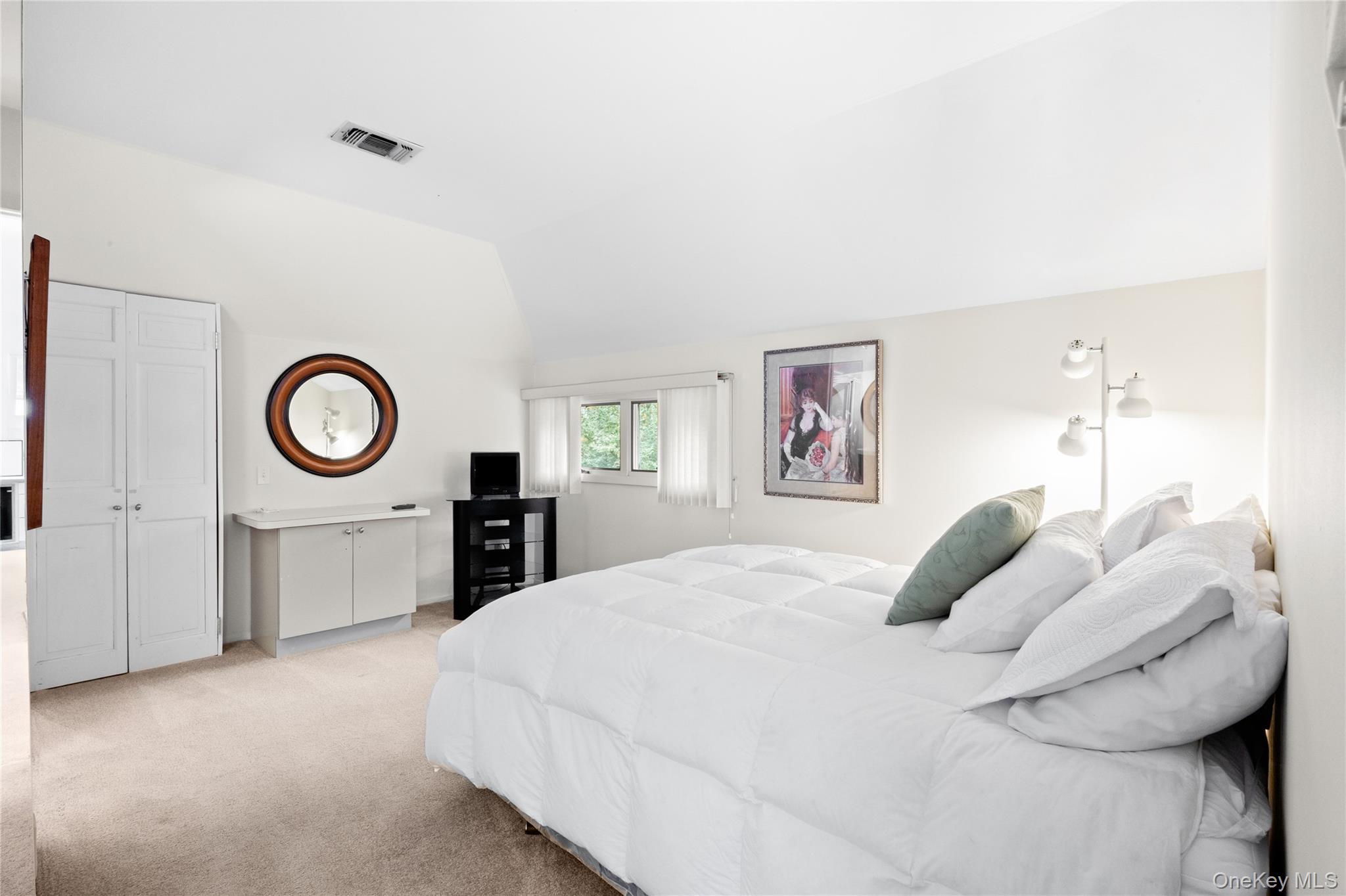 18 Golf Club Road St. James, NY 11780 - Photo 21 of 47 a bedroom with a bed and a lamp on table