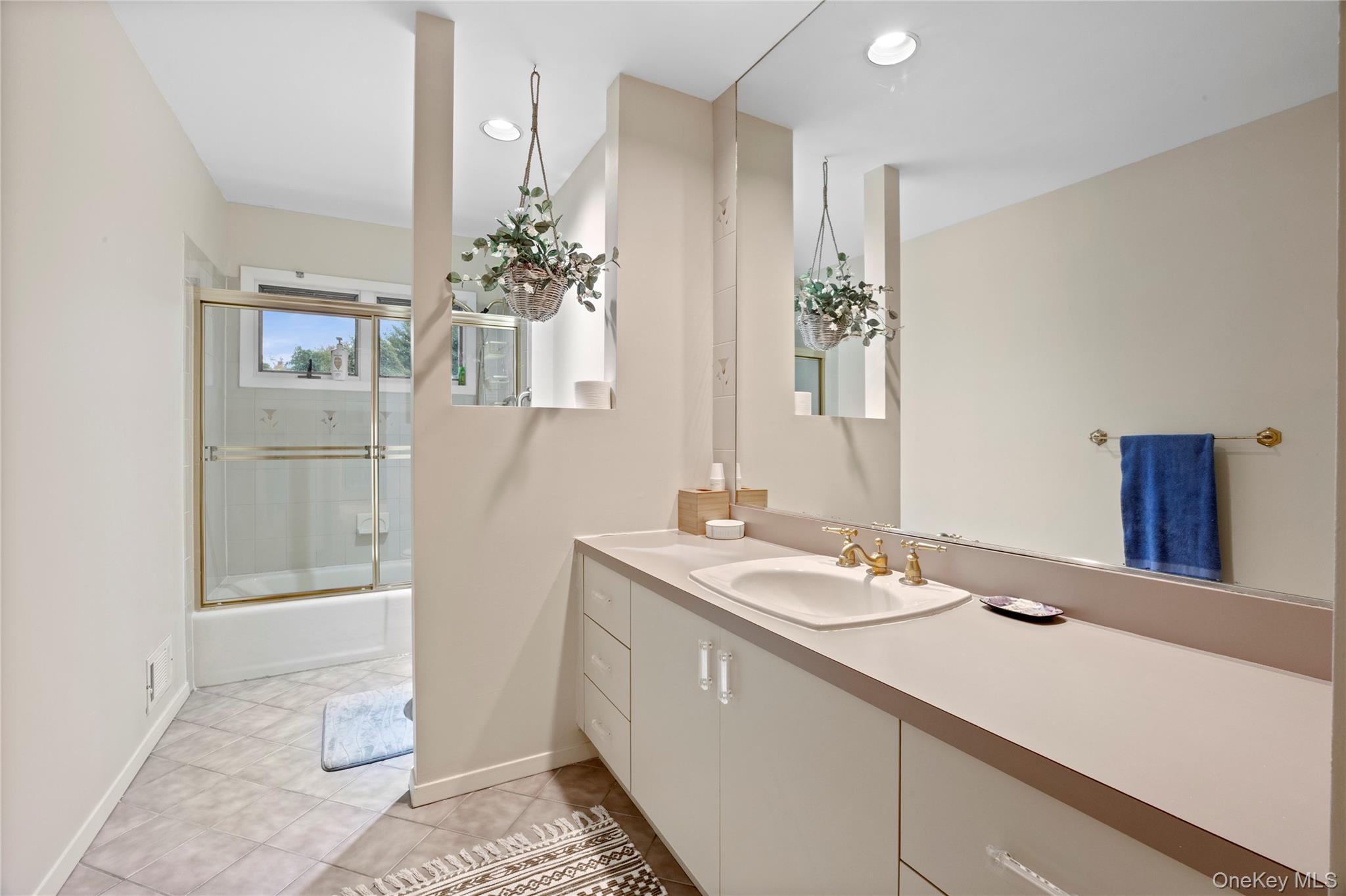 18 Golf Club Road St. James, NY 11780 - Photo 22 of 47 a bathroom with a sink a vanity and a mirror