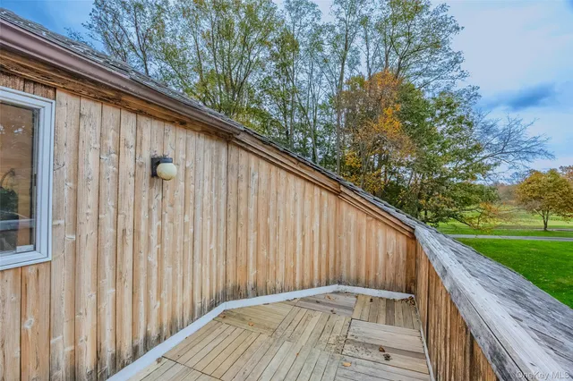 a wooden bench sitting in front of a house