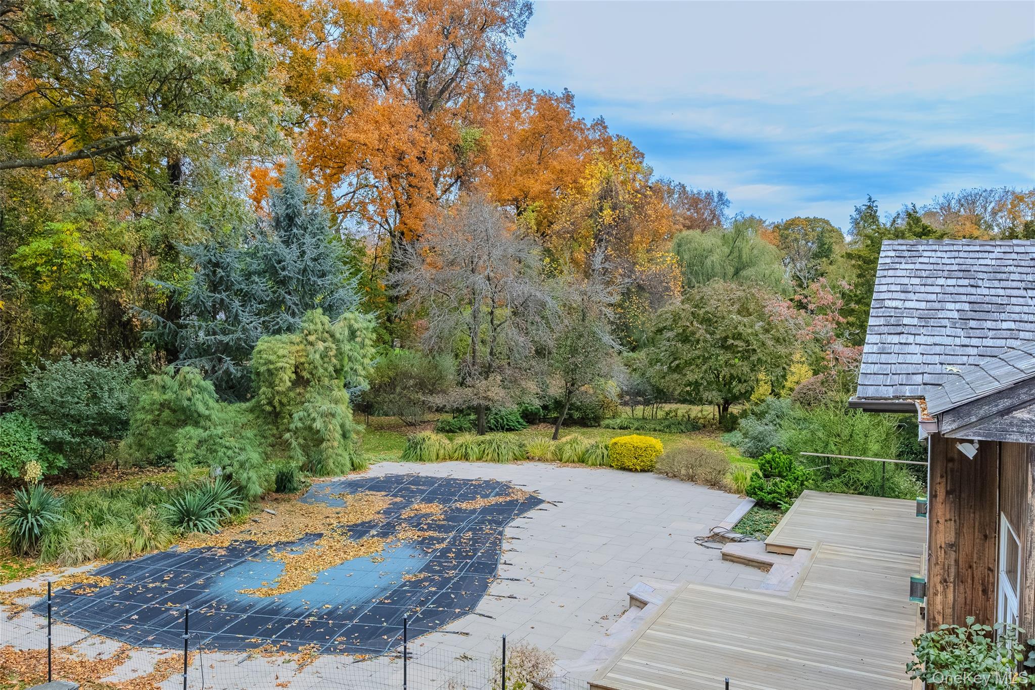 18 Golf Club Road St. James, NY 11780 - Photo 32 of 47 a view of a swimming pool with a patio and a yard