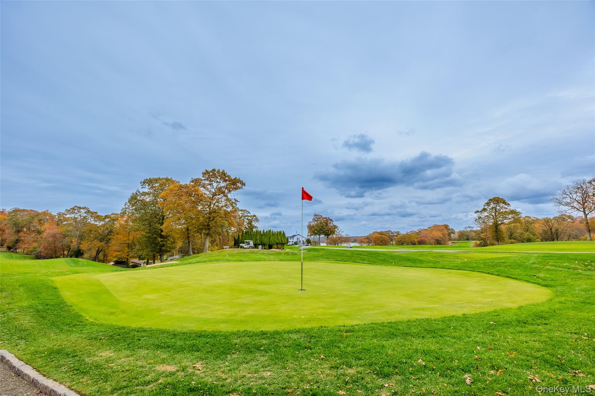 18 Golf Club Road St. James, NY 11780 - Photo 41 of 47 a view of a golf course with a lake