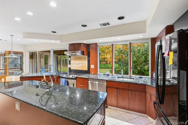 a kitchen with large windows and furniture
