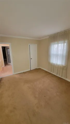 a view of an empty room and window