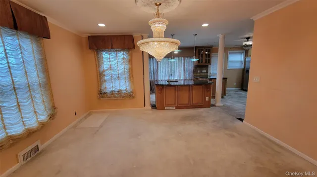 a view of a kitchen with a sink and a chandelier