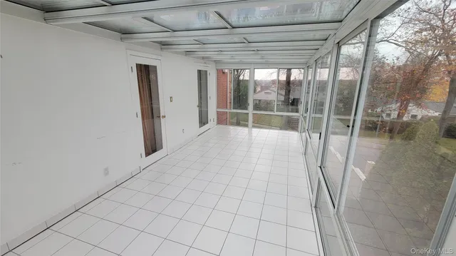 an empty room with closet and mirror