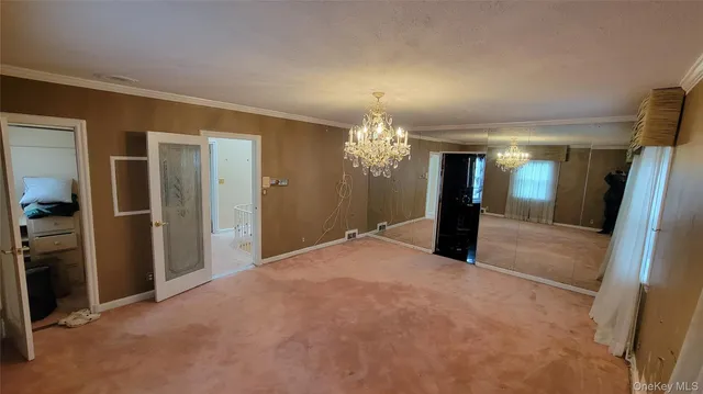 a view of a living room and chandelier