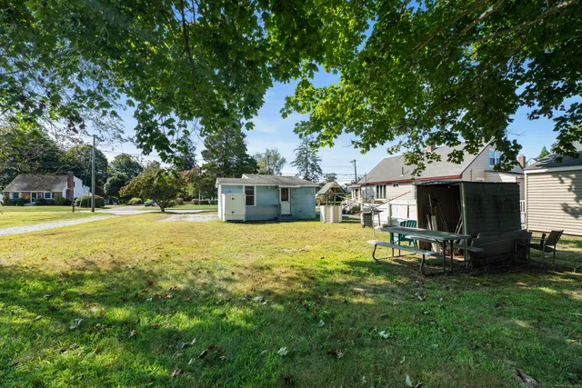 a swimming pool with outdoor seating and yard