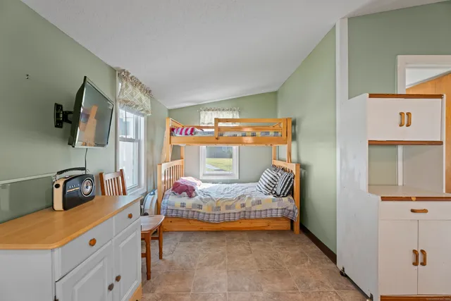 a bedroom with furniture and a flat tv screen