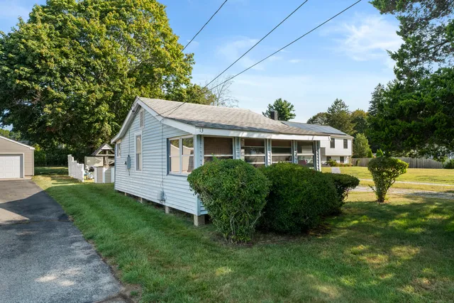 a front view of house with yard and green space