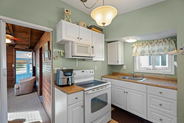 a kitchen with stainless steel appliances granite countertop a sink and cabinets