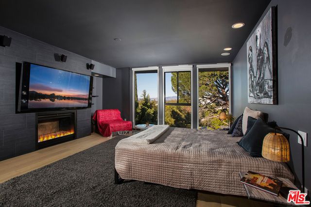 a bedroom with bed and wooden floor