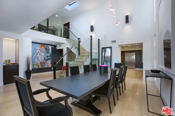 a dining room with furniture and wooden floor