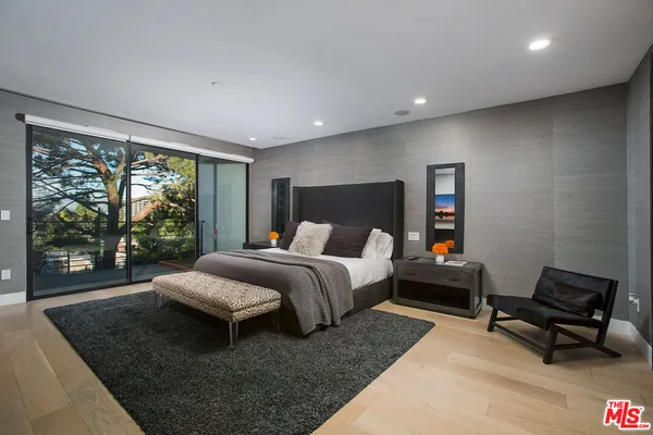 a spacious bedroom with a large bed and a couch