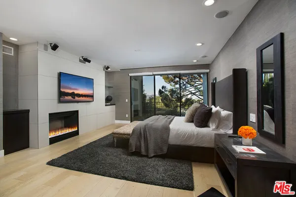 a bedroom with a bed and glass wall