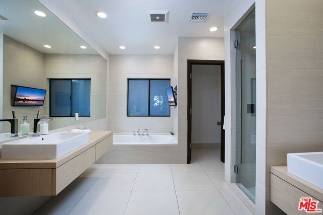 a spacious bathroom with a bathtub and a sink