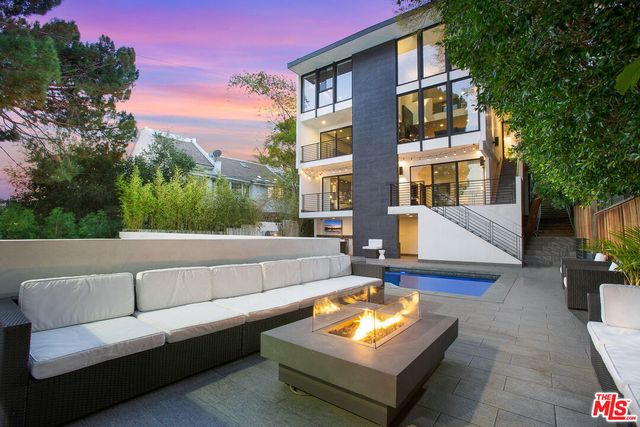 a view of a building and with couches in a patio