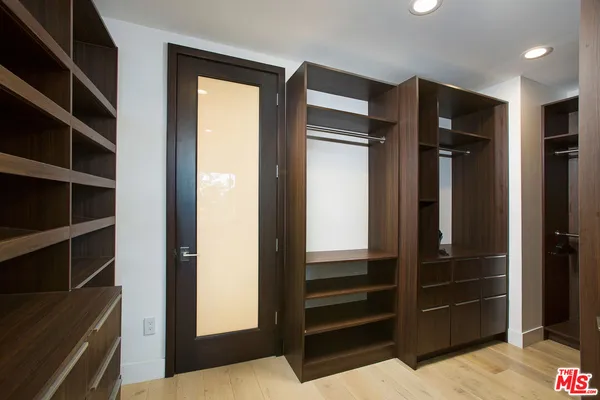 a view of walk in closet and bedroom