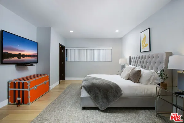 a bedroom with bed and a night stand