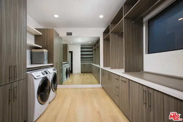 a view of a hallway with washer and dryer