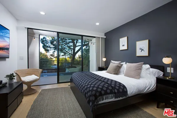 a bedroom with a bed and glass window