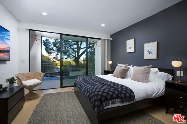 a bedroom with a bed and glass window