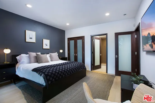 a bedroom with bed and walk in closet