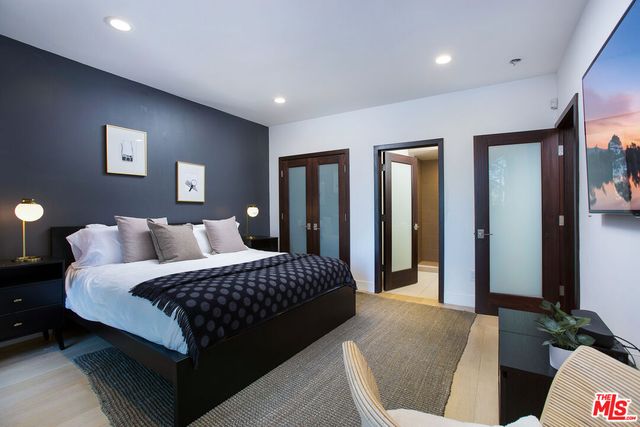 a bedroom with bed and walk in closet