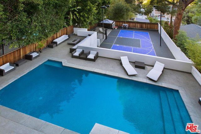 a view of a patio with lawn chairs next to a yard