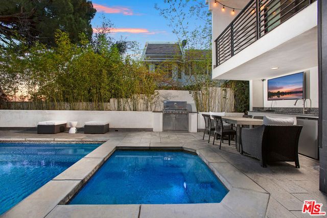 a view of kitchen and hall with dining area