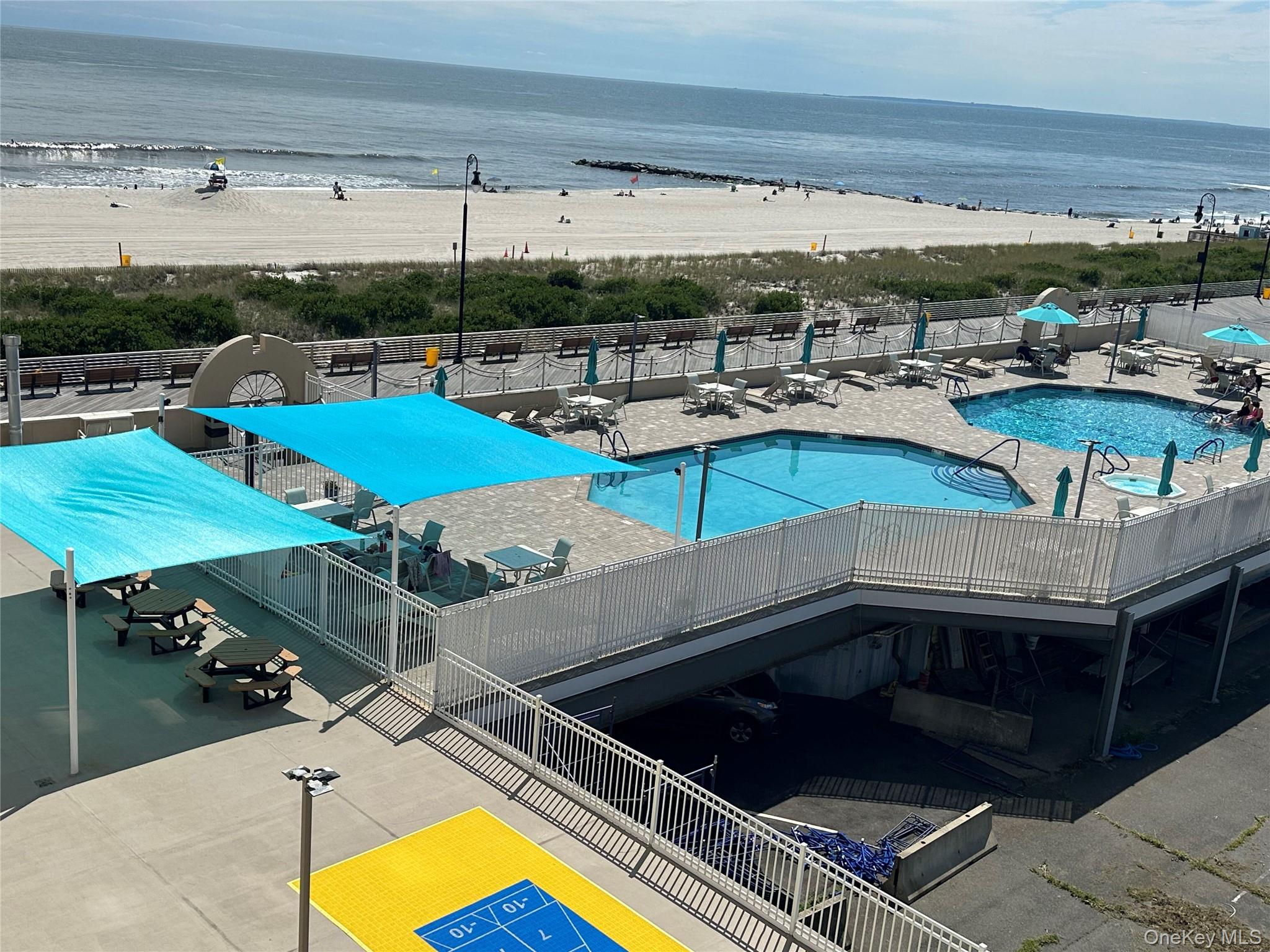 360 Shore Road, Unit 4B Long Beach, NY 11561 - Photo 11 of 28 a view of swimming pool with seating area and furniture