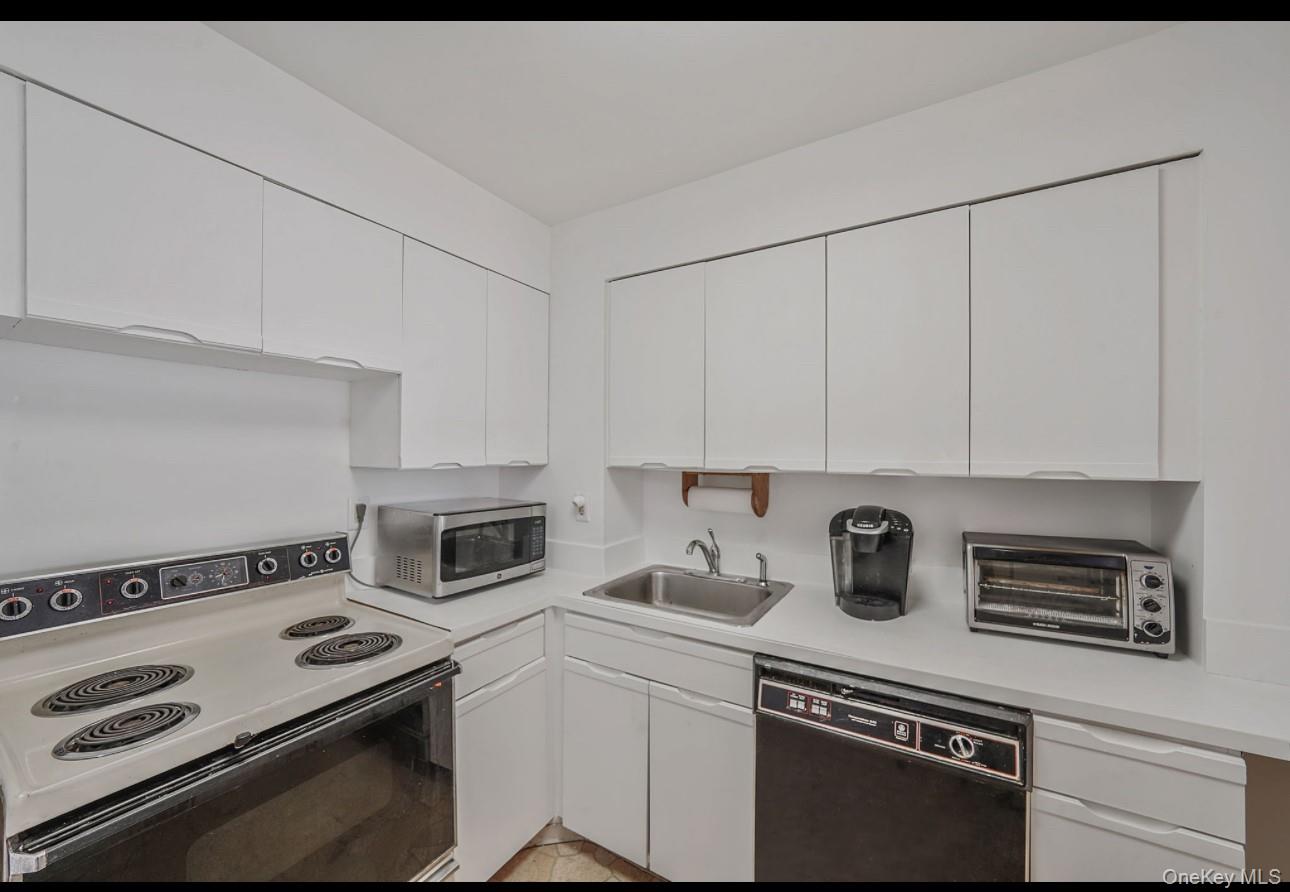 360 Shore Road, Unit 4B Long Beach, NY 11561 - Photo 12 of 28 a kitchen with a stove and a sink