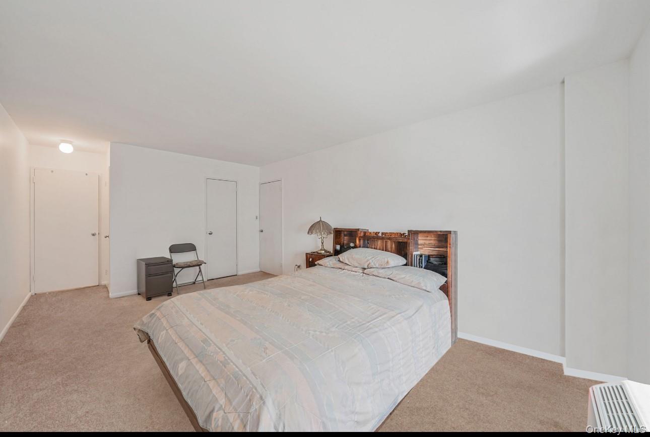 360 Shore Road, Unit 4B Long Beach, NY 11561 - Photo 23 of 28 a bed room with a bed and a chair