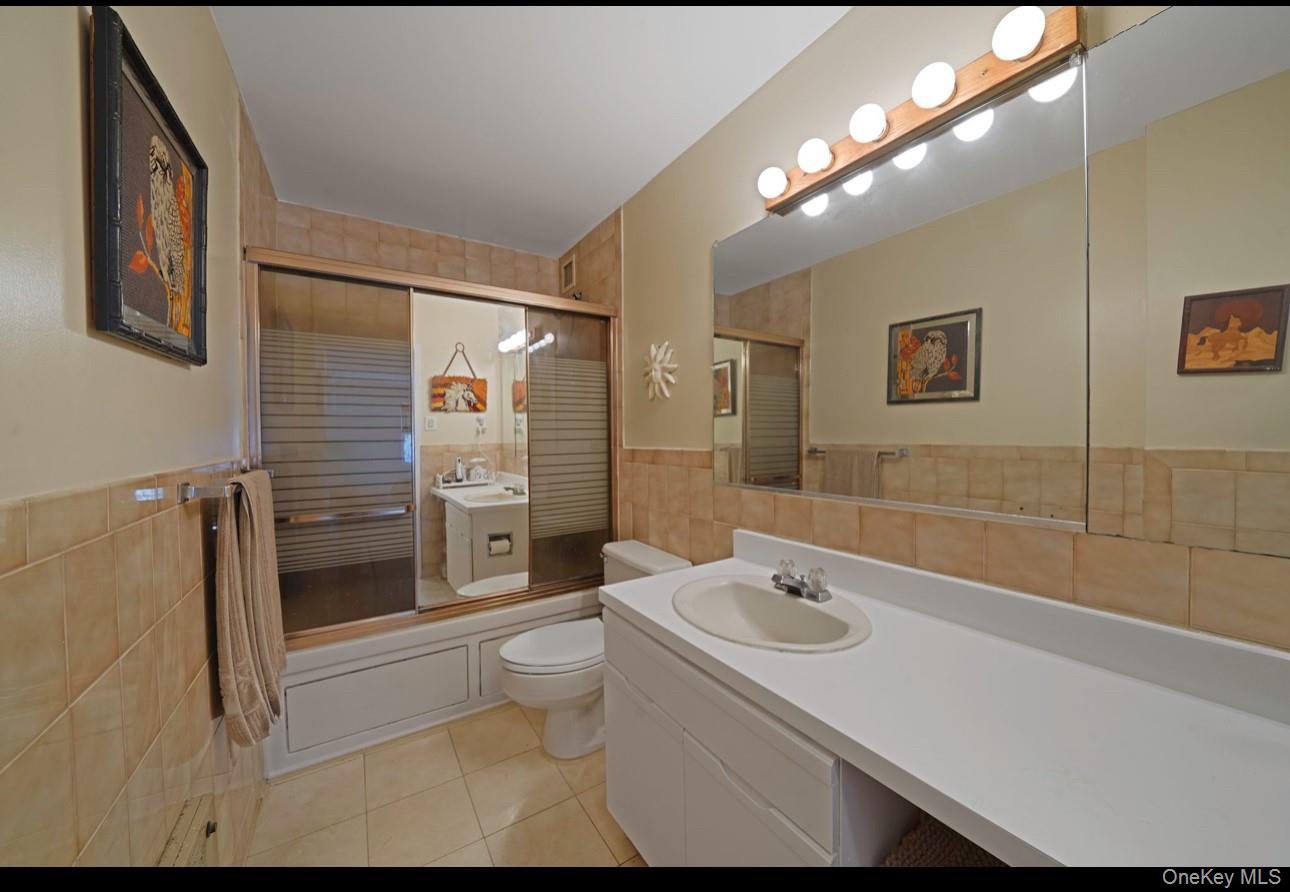 360 Shore Road, Unit 4B Long Beach, NY 11561 - Photo 24 of 28 a bathroom with a sink a toilet and shower