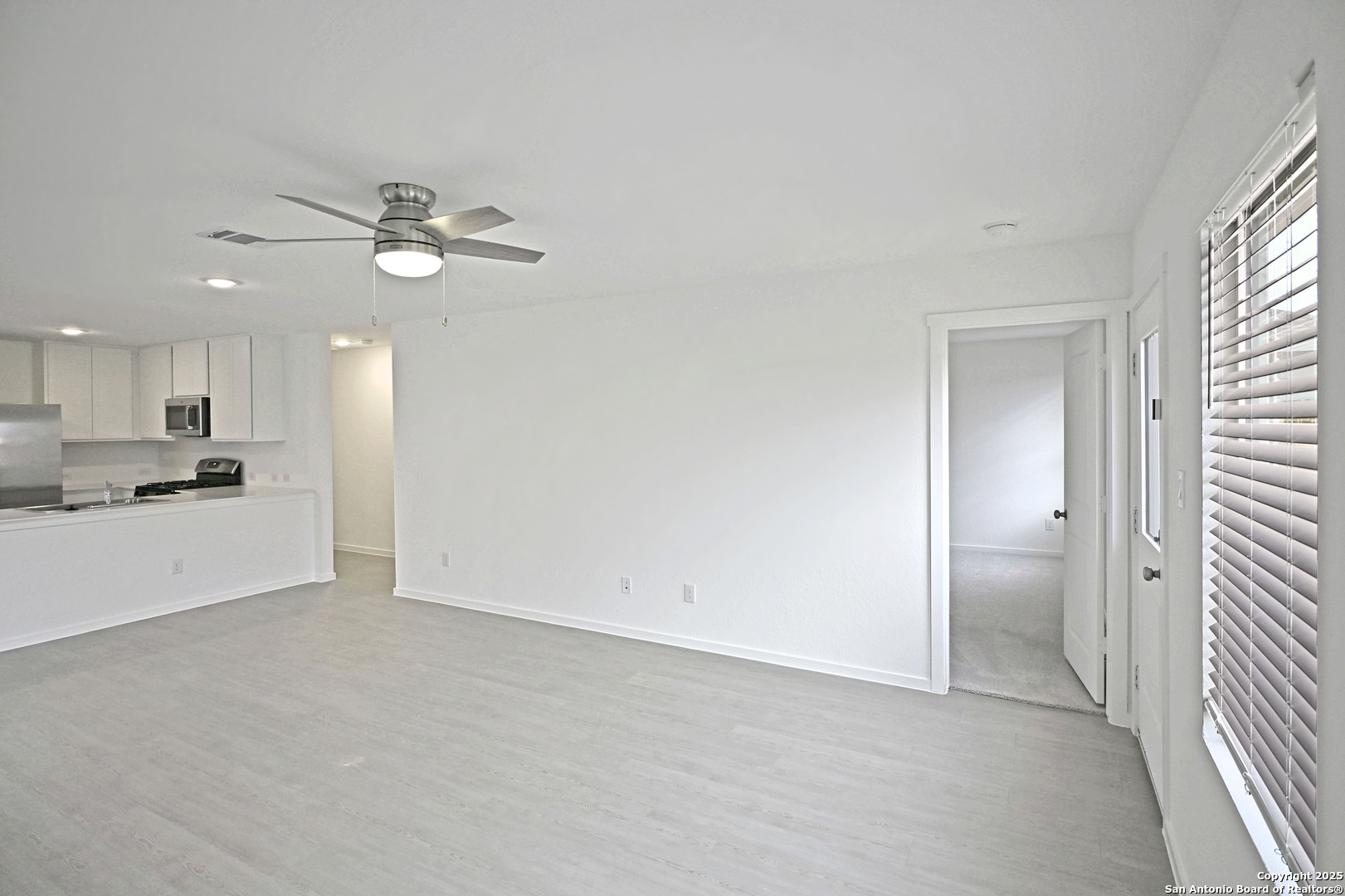3805 Swift Fox Road New Braunfels, TX 78132 - Photo 17 of 27 a view of a kitchen with a sink and a refrigerator