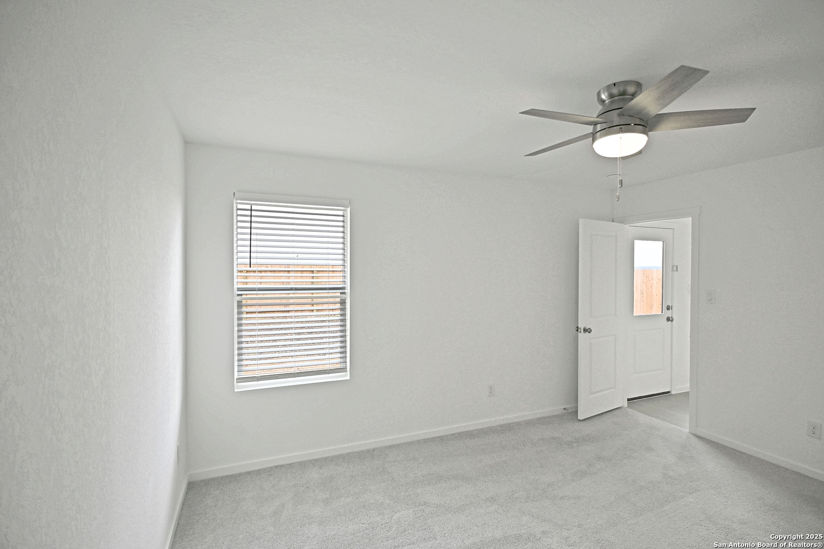 3805 Swift Fox Road New Braunfels, TX 78132 - Photo 19 of 27 an empty room with a window and ceiling fan