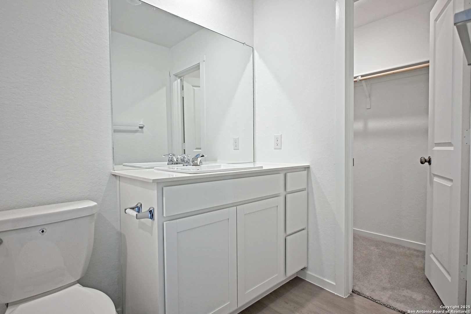 3805 Swift Fox Road New Braunfels, TX 78132 - Photo 20 of 27 a bathroom with a sink toilet vanity and a mirror