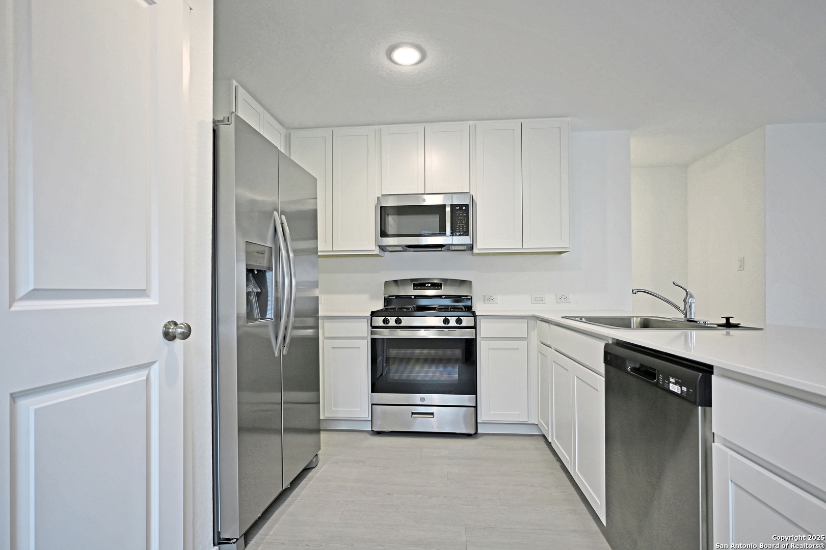 3805 Swift Fox Road New Braunfels, TX 78132 - Photo 4 of 27 a kitchen with a sink and steel stainless steel appliances