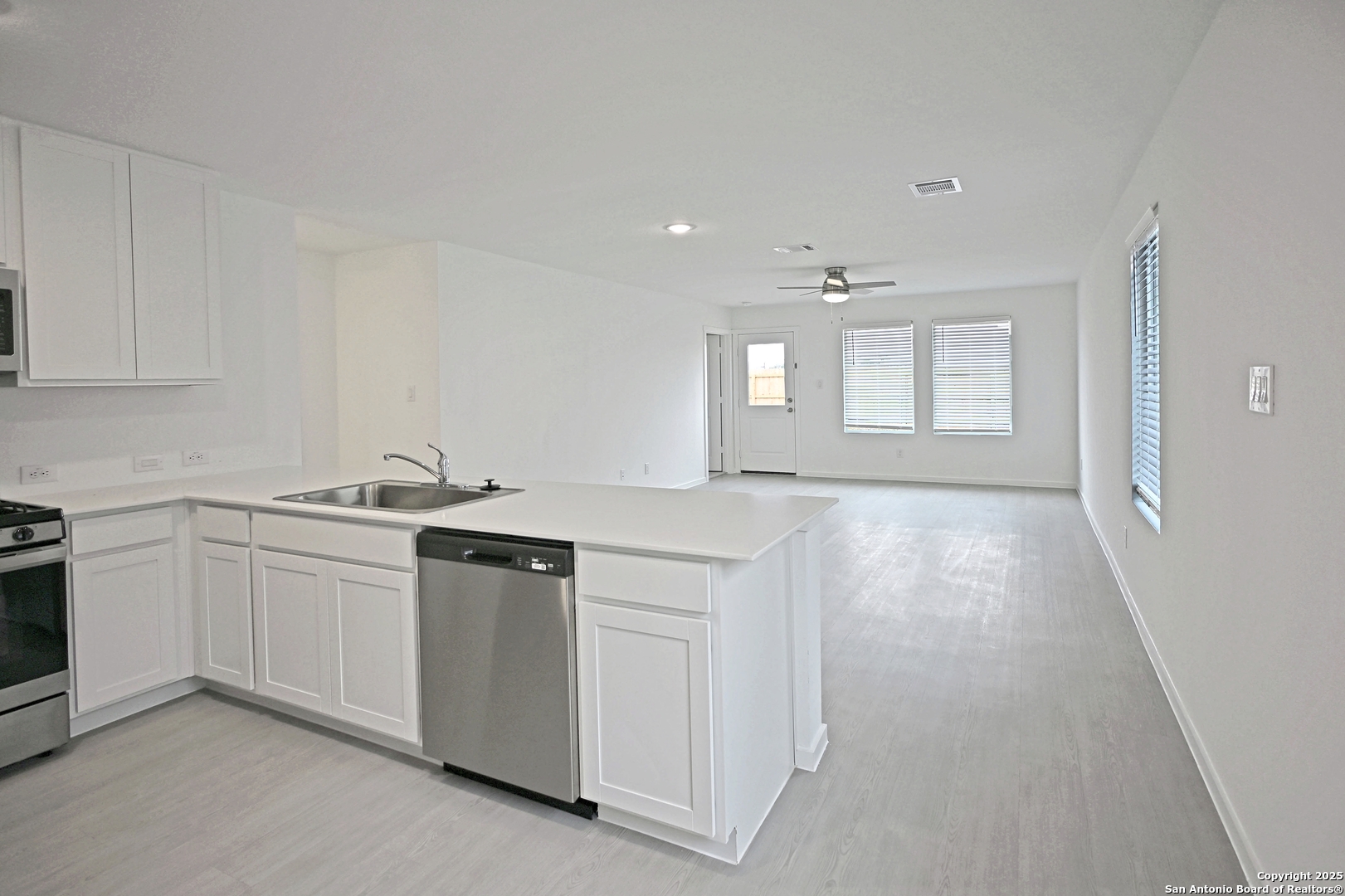 3805 Swift Fox Road New Braunfels, TX 78132 - Photo 5 of 27 a kitchen with white cabinets and sink