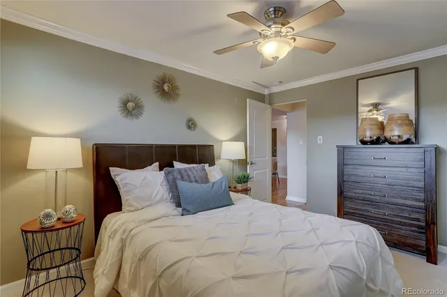 a bedroom with a bed and a lamp on dresser