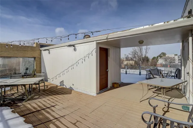 a living room with a couch and a table with wooden floor